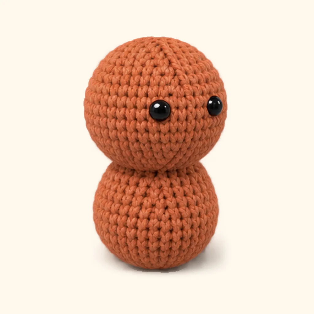 Gingerbread man crochet assembly: attach the head
