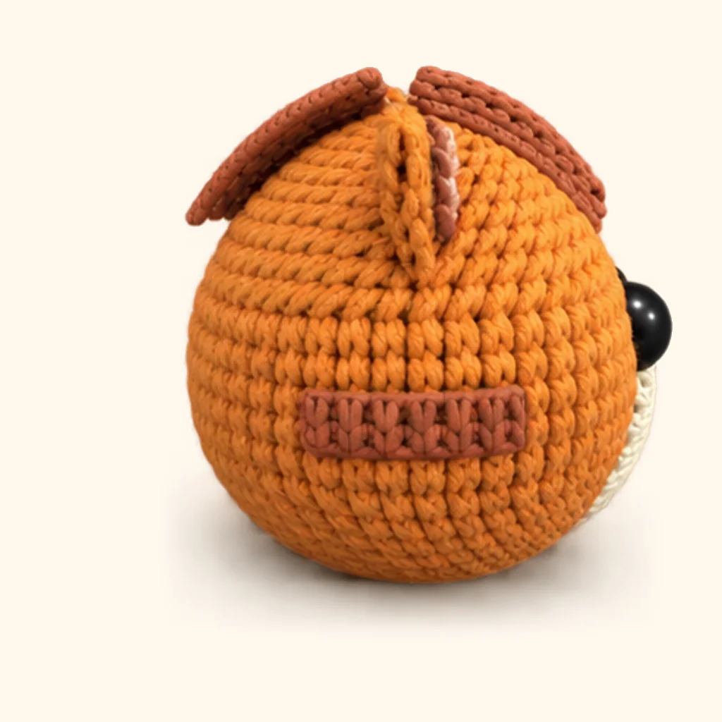 Orange tabby kitten crochet assembly: attach the upper cheek stripes