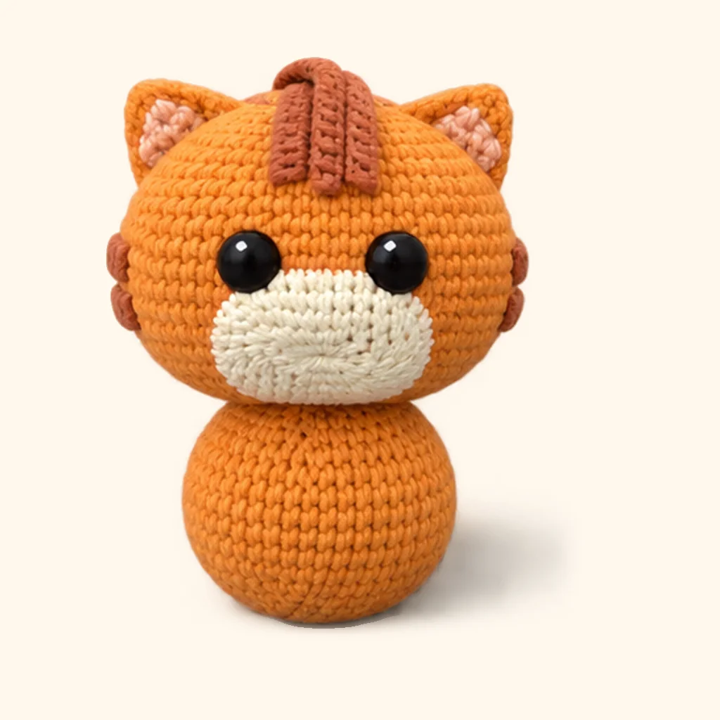 Orange tabby kitten crochet assembly: attach the head