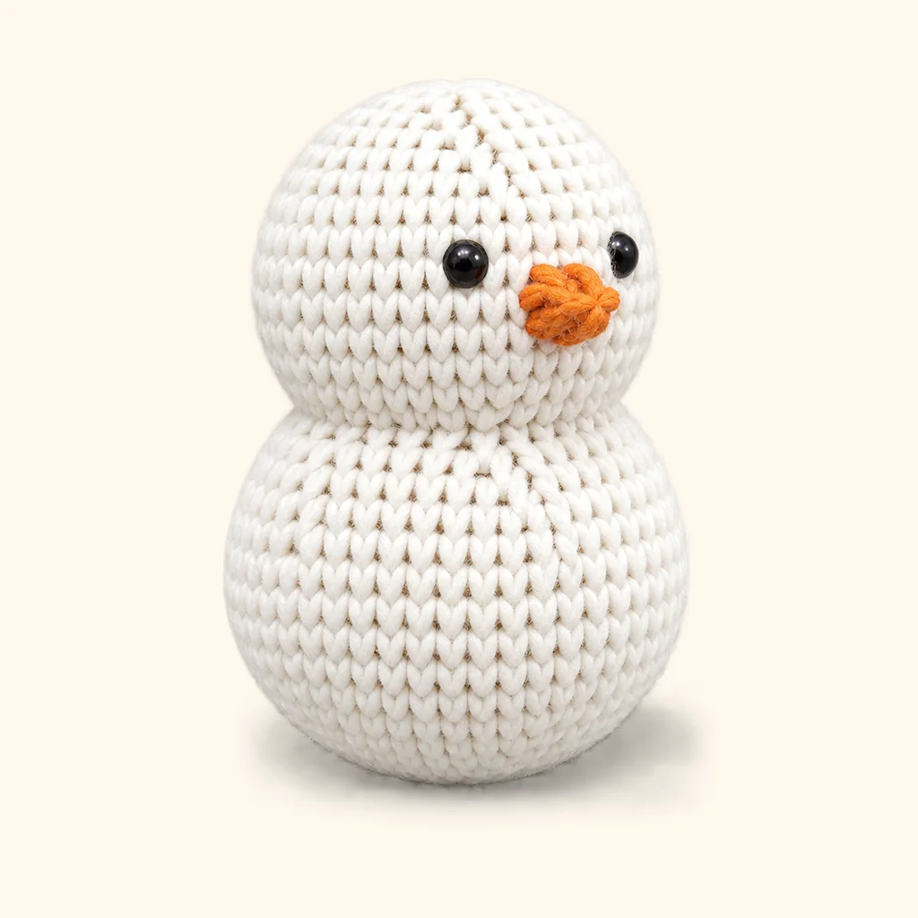 Snowman crochet assembly: attach the carrot nose