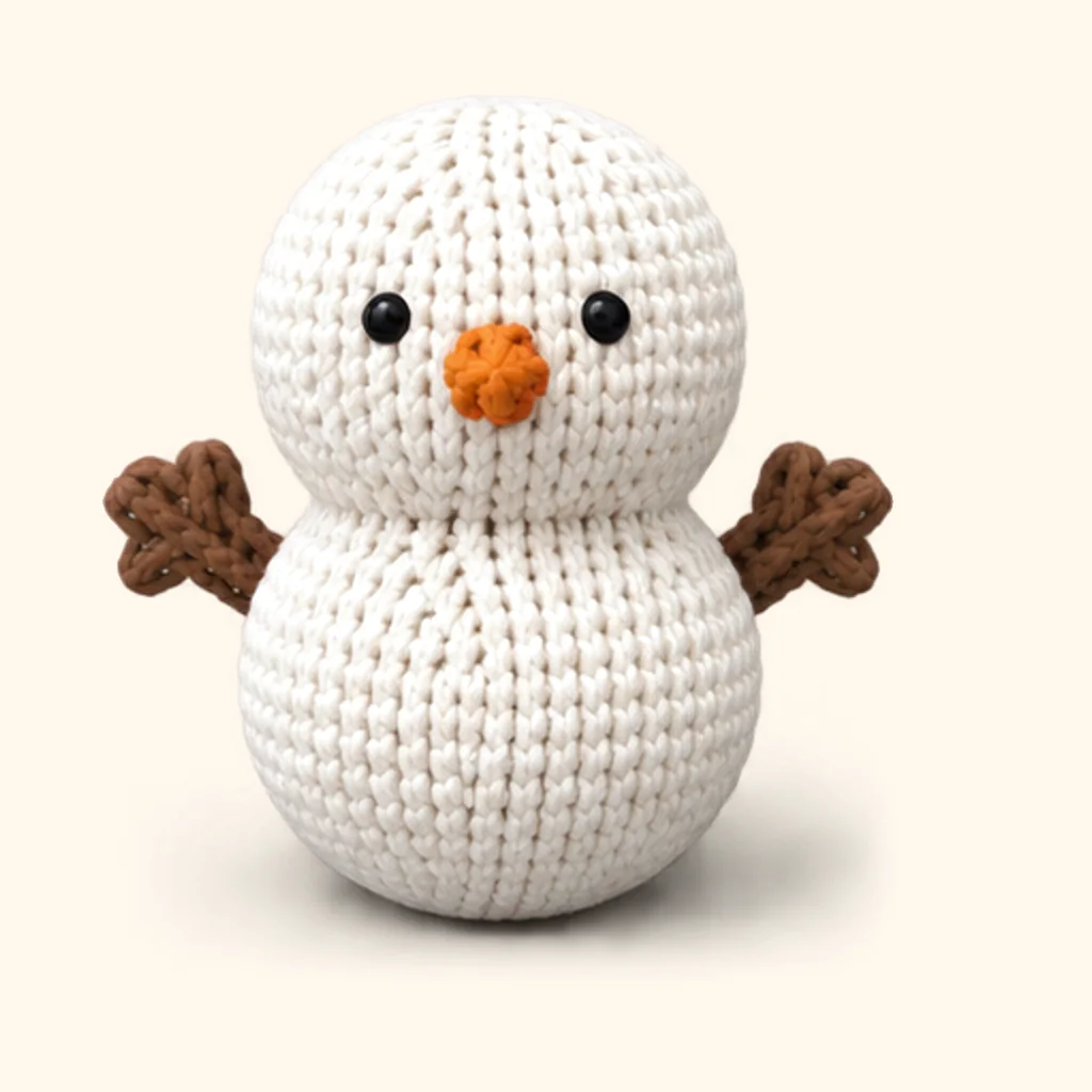 Snowman crochet assembly: attach the twig arms